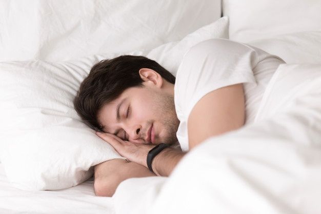 young-guy-sleeping-bed-wearing-smartwatch-sleep-tracker_1163-5232.jpg